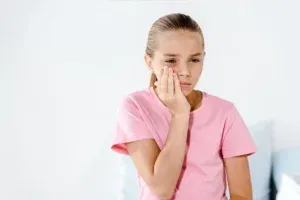 Sad Kid Touching Cheek While Having Tooth Ache 2023 11 27 04 50 59 Utc